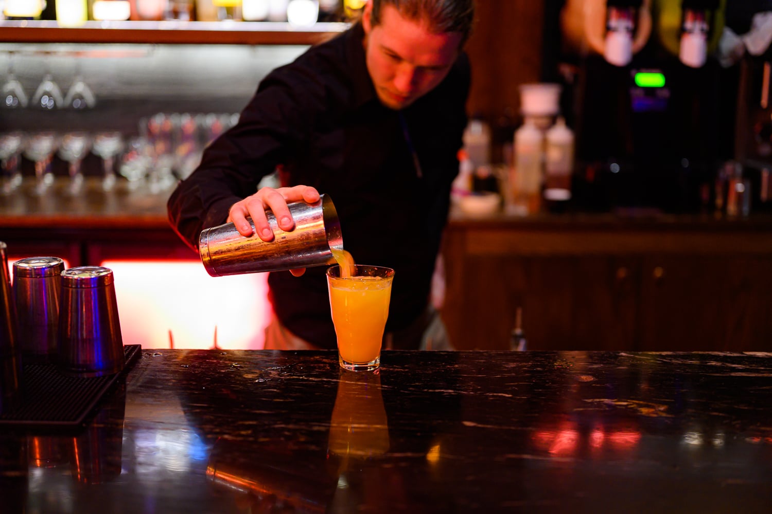 Bartender pouring a cocktail
