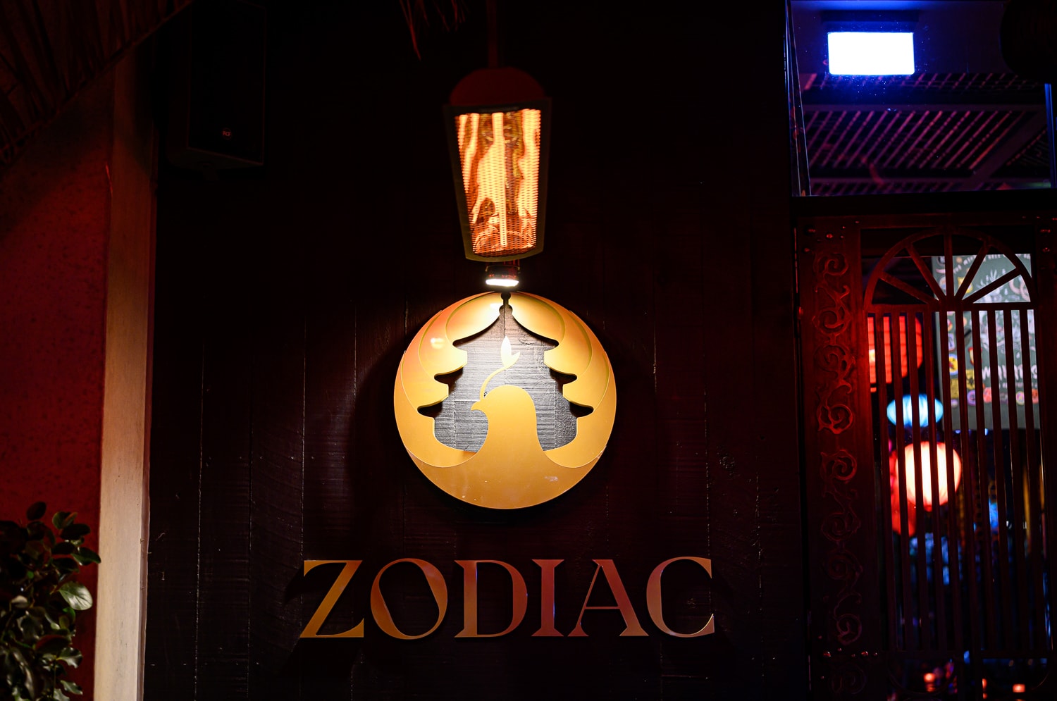 The glowing Zodiac emblem beneath a lantern