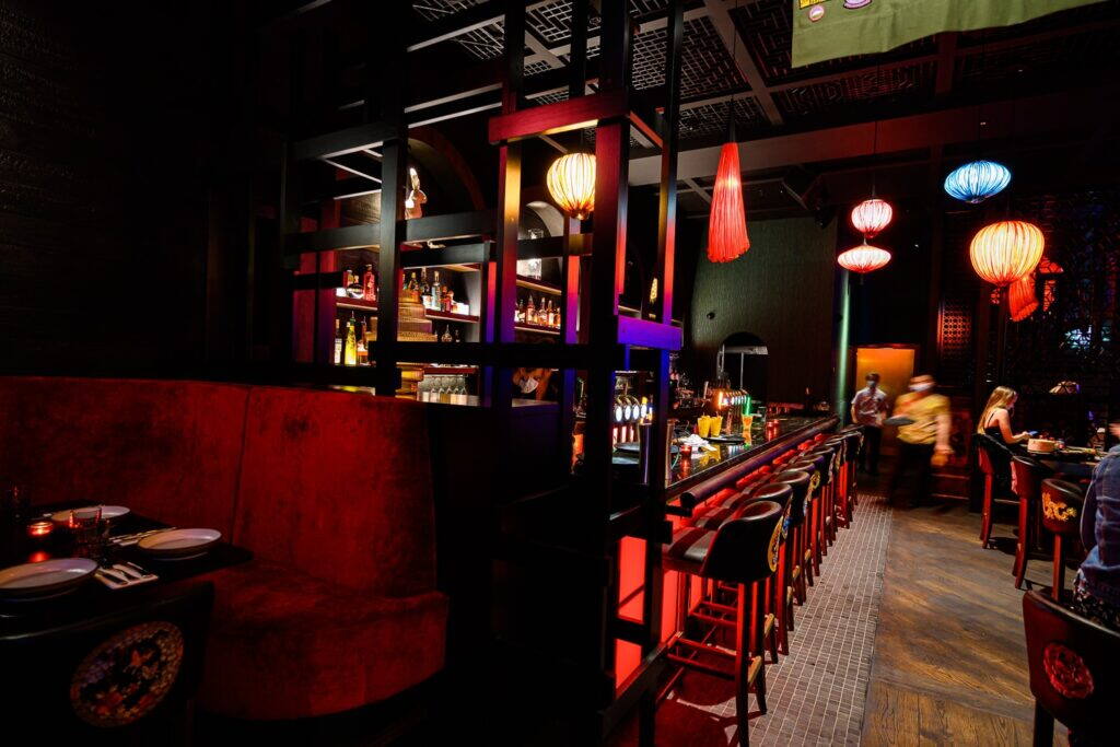 Red velvet booths and the lantern-lit bar at Zodiac